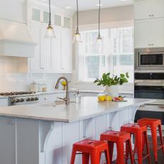 Contemporary Kitchen With White Cabinets, Kitchen Island & Bold Red Barstools 