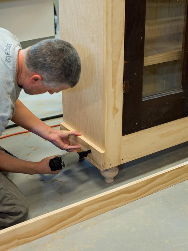 With brad nails (1-1/4” or 3/4” depending on size of trim), tack in 1 x 4” boards, cut to size, into top and bottom of cabinet. Add decorative molding as desired, cutting to size of a miter saw. Paint, stain or finish as desired.