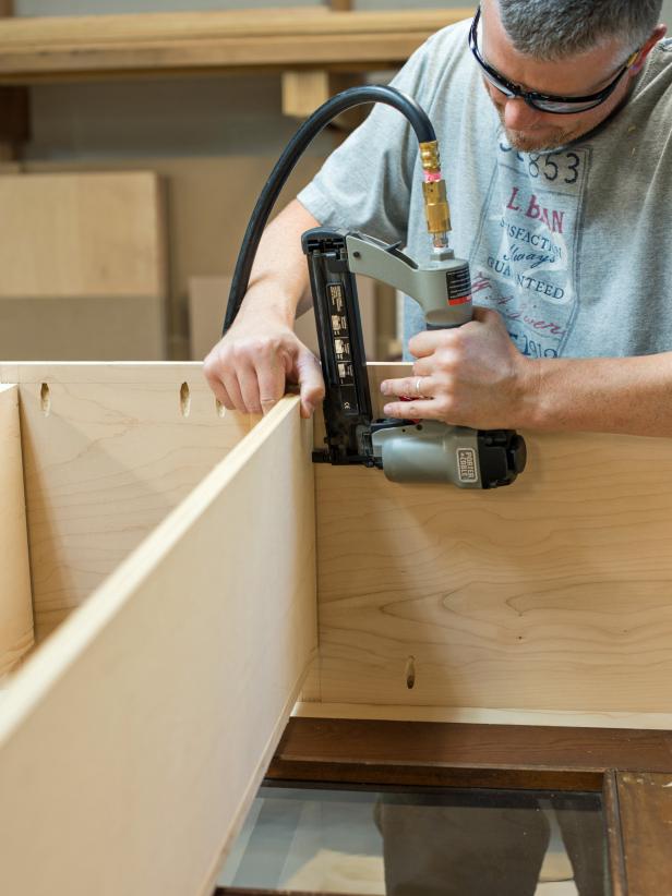 Cut 1 x 2” boards to width of shelves. Tack to the front of each shelf with 1-1/4” brads to cover raw plywood edge. Position shelves on shelf supports and nail into place with brads. Bottom shelf can be full width and depth of cabinet and does not require trim.