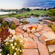 A Circular Stone Fire Pit With a Lake View
