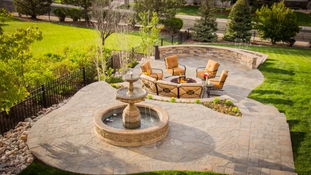 Serene Stone Patio With Water Feature and Fire Pit | HGTV