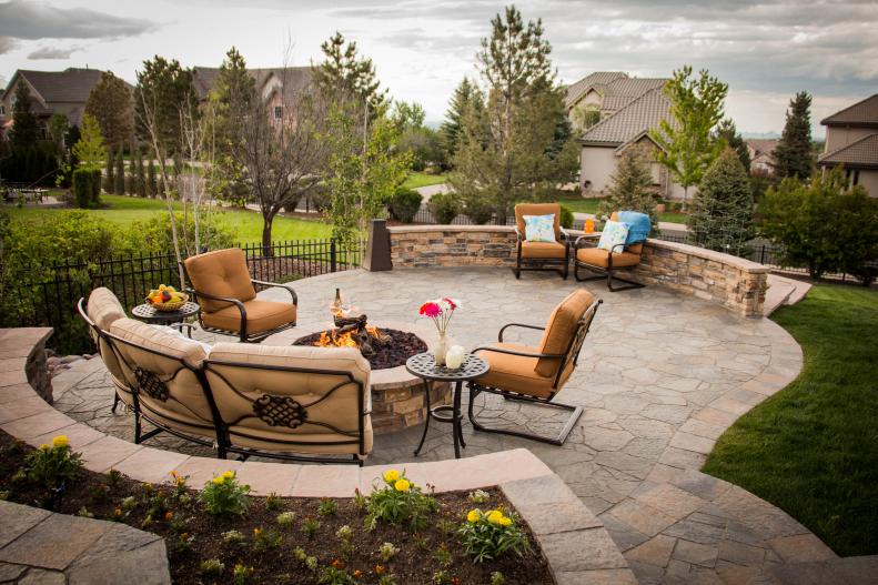 A stone patio with a fire pit