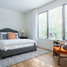 Gray and White Contemporary Bedroom With Orange Chair