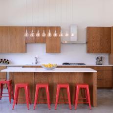 White Modern Kitchen With Red Barstools