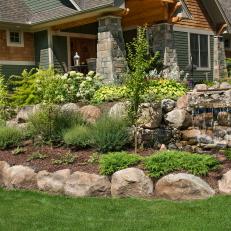 Front Entry Landscaping With Rock Details, Waterfall and Lush Plant Life 