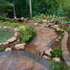 Beautiful Backyard Landscaping With Paver Patio Pathway, Stone Pond and Mulched Planter Areas 