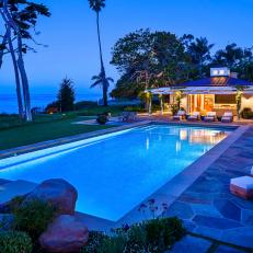Stone Patio With Pool, Lounge Chairs and Gazebo at Twilight