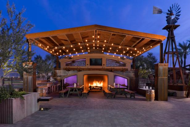 Modern Outdoor Dining Area with Wood Pergola, Picnic Tables and Fireplace
