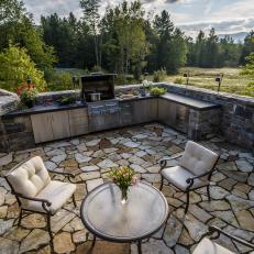 Rustic Outdoor Kitchen with Stainless Steel Appliances and Stone Work