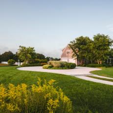 Spacious Yard With Driveway Circle, Brick Home Exterior and Vivid Plant Life 