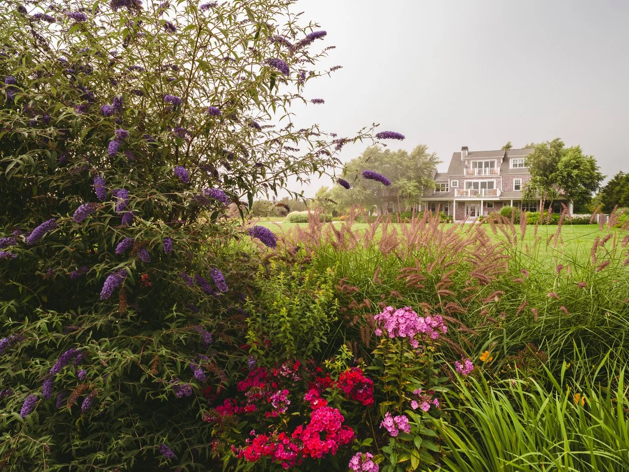 Colorful Wildflowers Surround Home With Long Porch and Pool | HGTV