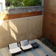 Aerial View of Asian Outdoor Sitting Room With Striped Patio Floor, Copper Accent Wall and Succulent Garden 