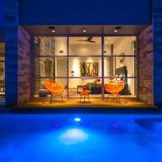 Poolside Modern Outdoor Orange Chairs at Nighttime