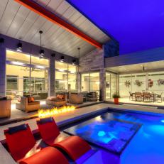 Orange and Cool Tones Complement Modern Pool Lounge Area