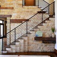 Staircase Features Stone Walls With Wood Accents