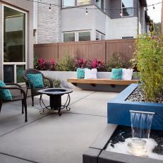Small Backyard With Blue Block Planter and Floating Bench