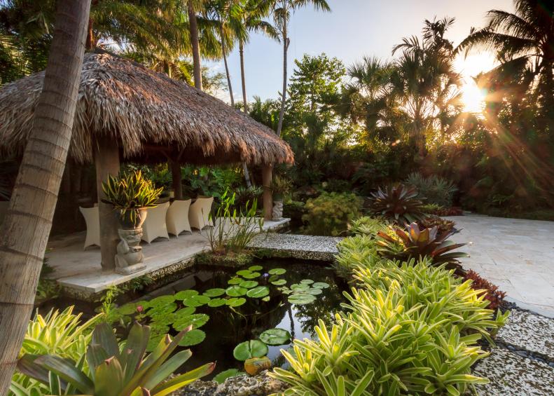 Tropical Landscape Design with a Water Feature, Bridge and Hut