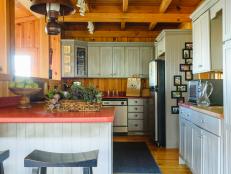 The quaint kitchen of Ron and Jane Bladon’s north Georgia mountain house is packed with traditional country charm. From its painted beadboard cabinets to the barn red coloring of the hardy engineered stone countertop, the kitchen fits their home’s architecture as well as their busy lifestyles. 