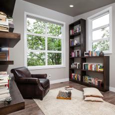 Cozy Reading and Game Nook With Shelving and Leather Chair