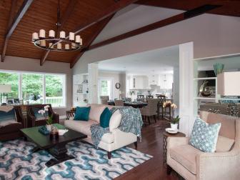 Great Room - After 4: Formerly dated and dark, after the renovation, the great room in Craig and Laurel Perler's Armonk, New York, home is stylish and inviting, with a well-defined seating area, a fireplace feature with flatscreen, and the couple's piano, as seen on Property Brothers. (After)