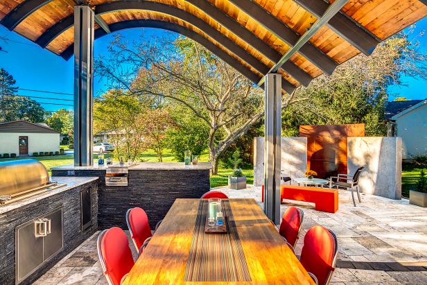 Outdoor Kitchen and Dining Area with Adjacent Fireplace Area
