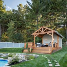 Stone Pathway Leading to Poolhouse With Covered Cedar Deck