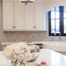 Bright White Kitchen With Farm Sink and Island