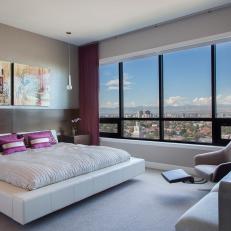 Modern Master Bedroom Features Floating Bed & Elegant Armchair