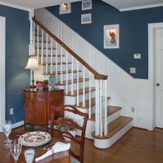 Traditional Formal Dining Room With Blue Walls, Built-In Shelves & Timeless Buffet