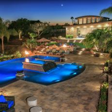 Gorgeous View of Tropical Landscaping and Levels of Hardscaping in Luxury Backyard With Swimming Pool and Fire Pit