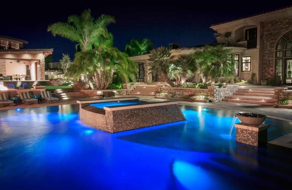 Luxurious Tropical Swimming Pool With In-Pool Tile, Water Features and Palm Trees
