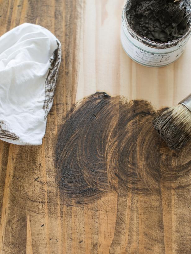 With wax brush or old paintbrush (one that has splayed bristles), apply stained furniture wax to table, working wax into gouges and marks made in step one. Wipe excess wax away with clean, lint-free cloth. Buff wax by hand, in circular motion, until finish is smooth. If finish feels sticky or tacky, too much wax was applied.