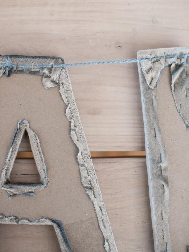 Cut length of twine, ribbon or string that is long enough to attach letters together, creating a banner, plus an allowance on each side to hang letter. Staple to top back side of letters, making sure letters are evenly spaced. Tip: Hot glue could also be used for this project.