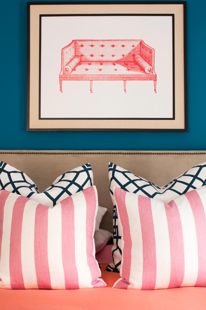 Pink Framed Print Behind Headboard With Striped Pillows