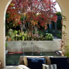 A Terrace Archway Frames A Courtyard Water Feature