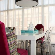 Eclectic Dining Room With Hot Pink and Ghost Dining Chairs