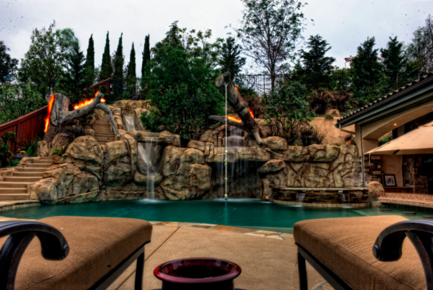 A Pool Playground For Everyone Features A Faux Rock Waterfall Rope Swing Water Slide And Spa Hgtv