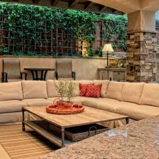 Plenty of Seating Welcomes Visitors to This Stone-Accented Pool Cabana