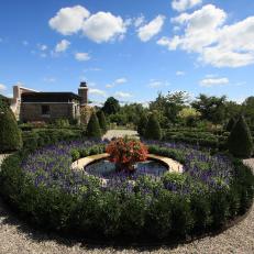 A Round Fountain Layered with Plants in a Formal English Garden