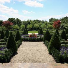 A Formal English Garden with Boxwood Topiaries and Fountain