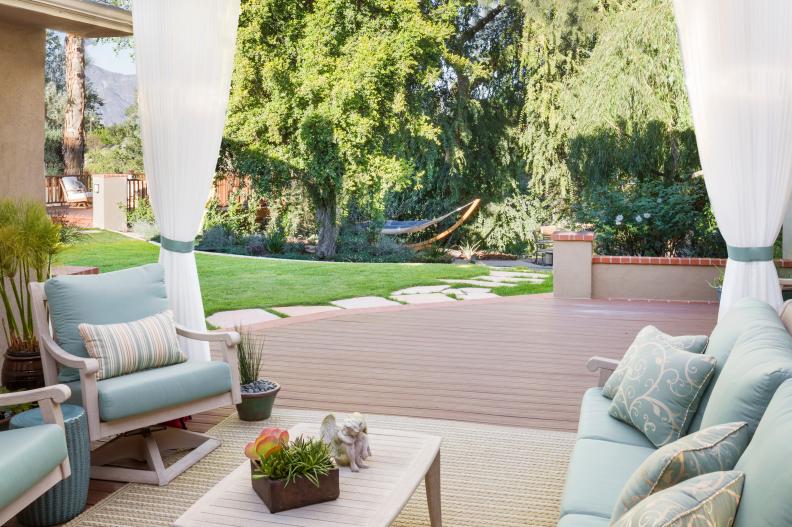 A wood patio with lounge furniture