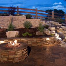 An Inlaid Stone Fire Pit Adds Warmth and Brightness to a Backyard Landscape
