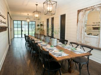 Long Dining Table with Place Settings and Contemporary Light Fixtures