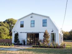 The exterior of the Meek home has been completely transformed with new windows, large sliding barn doors, light fixtures, and landscaping, as seen on Fixer Upper. (exterior)