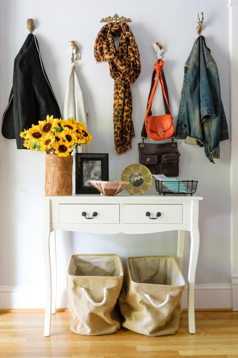 Whimsical Wall Hooks Hanging Above Small Console Table