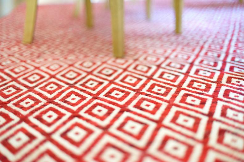 Closeup of Red-and-White Area Rug With Diamond Pattern