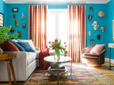 Blue Transitional Family Room With Hand-Carved Masks and Turkish Rug
