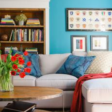 Blue Living Room With Built-In Bookcase and Framed Art