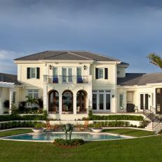 Grand Waterfront Home Exterior With Swimming Pool and Spacious Lawn 