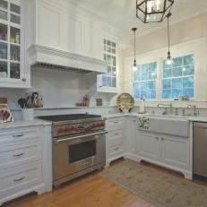 Marble Countertops, Glass Door Cabinets and White Range Hood in Sunny Traditional Kitchen 
